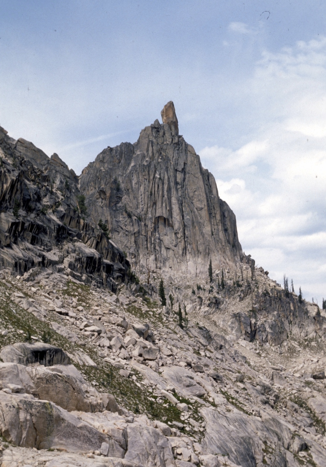 Southeast side of Big Baron Spire. Becky route traverses to just below the notch from cliffs on left of photo, then stays near ridgeline to the summit block. Ray Brooks Photo