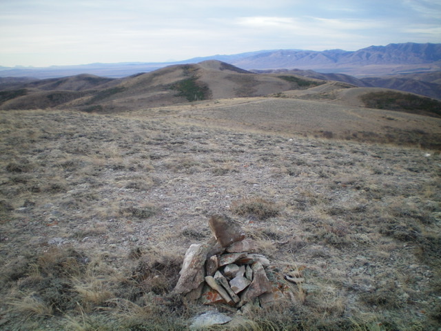 The summit cairn atop Peak 6890, looking southwest along the ridgeline to Point 6836 with Peak 6842 behind it. Livingston Douglas Photo