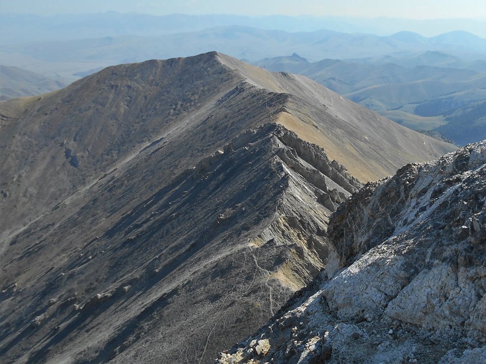 Pat avoided the 20 foot crack that I climbed and utilized an nearby exposed white slab (shown in this photo) that starts on the east side of the ridge and wraps around to the west side. Pat McGrane Photo