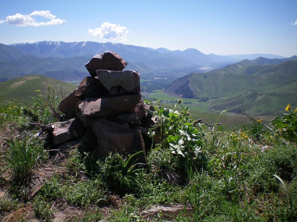 The summit cairn atop Peak 7315 with Hailey on the valley floor in the distance (upper right of photo). Livingston Douglas Philadelphia