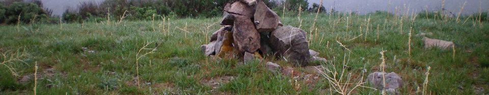 The newly-built summit cairn atop Peak 7058, on a cold, rainy morning in mid-May. Livingston Douglas Photo