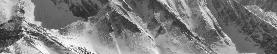 The Northwest Ridge is in the center of the photo. This ridge branches into two separate ridges lower down on the mountain, one into the Rock Creek drainage and the other forms the edge of the West Face. The Southwest (Chicken-Out) Ridge is on the right skyline. Photo by John Platt
