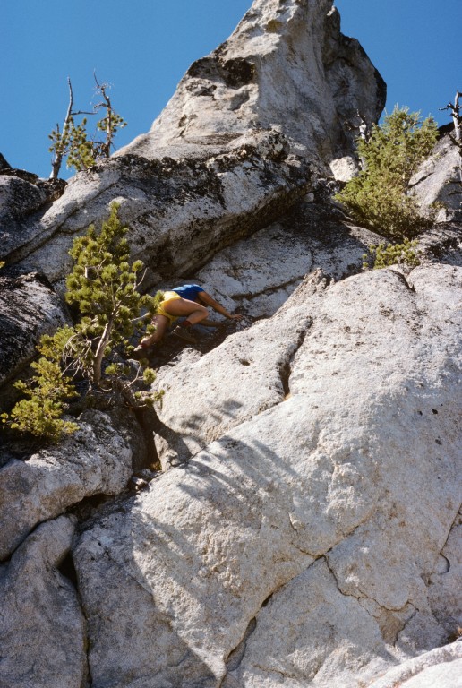 A climber moving up the Class 4 route to the high point of Needles Peak is located one third of the way up the route.