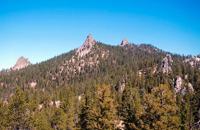 Needles Peak from the southwest. Three of the granite towers on this peak are visible in this photo. There are a large number of one and two pitch routes on these formation many of which were first climbed by Doug Colwell.